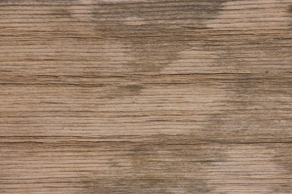 Close-up of aged wooden surface with natural texture and stains.